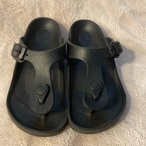 Birkenstock Kids Black rubber. Little bite mark from dog on one side